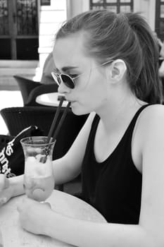a teenager at the resort in Croatia drinks a non-alcoholic cocktail
