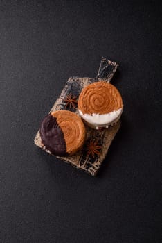 Round sweet New York roll croissant with chocolate cream filling on a dark concrete background