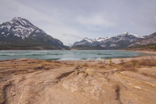 Spring hike scenery of textured ground, Barrier Lake and Mount Baldy.