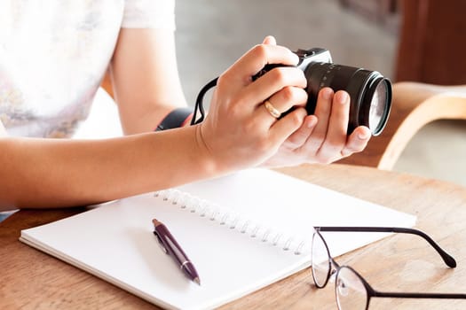 Woman with camera in the hands, stock photo
