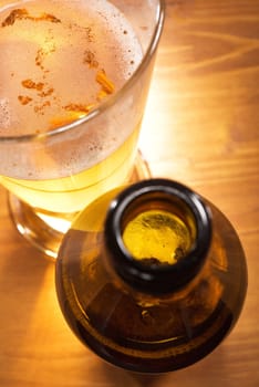 Close-up of a beer glass with beer bottle on the table
