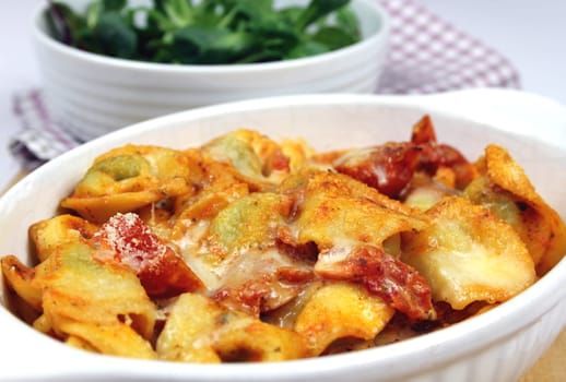 parmesan baked tortellini in tomato cream sauce with lettuce