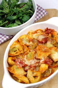 Tortellini baked with Parmesan in tomato and cream sauce with salad