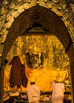 The ritual of daily face washing Mahamuni Buddha in Mandalay, Myanmar