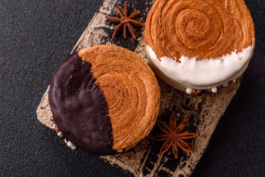 Round sweet New York roll croissant with chocolate cream filling on a dark concrete background