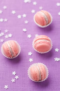 Pink macarons with buttercream filling on pink