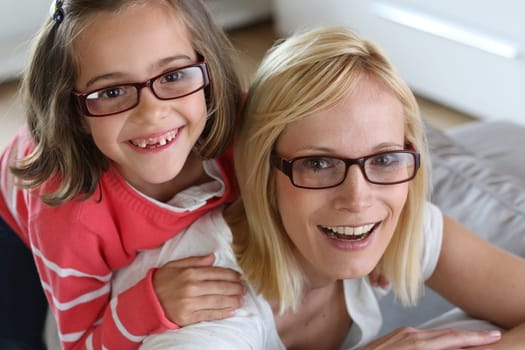 Mother and daughter with eyeglasses on