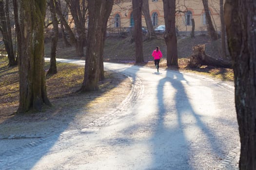 Lady running in the forest.  Running woman. Female runner jogging during outdoor workout in a Nature. Fitness model outdoors. Weight Loss. Healthy lifestyle.