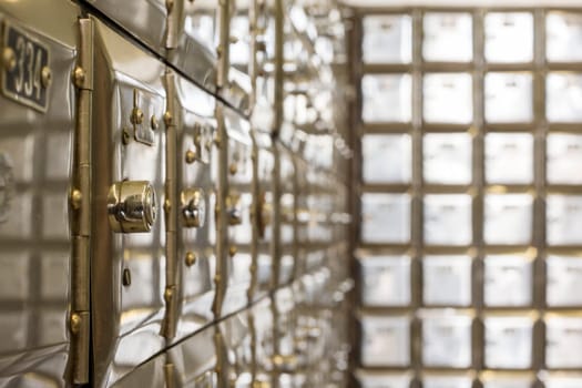 Many po boxes at the post office. The mail boxes are lined up in rows and columns. Selective focus