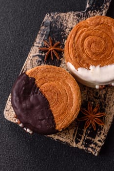Round sweet New York roll croissant with chocolate cream filling on a dark concrete background