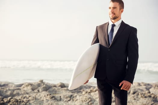 A Businessman holding is surfboard after a long day of work