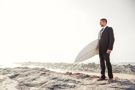A Businessman holding is surfboard after a long day of work