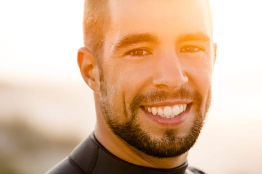 Outdoor portrait of an handsome young surfist smiling