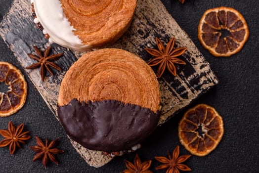 Round sweet New York roll croissant with chocolate cream filling on a dark concrete background