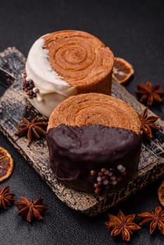 Round sweet New York roll croissant with chocolate cream filling on a dark concrete background