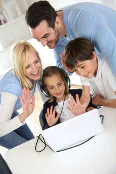Family using webcamera to communicate with loved ones