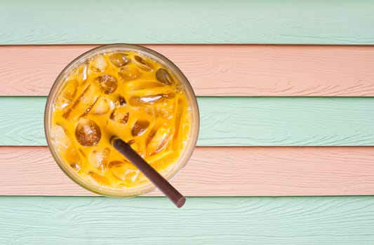 Ice milk tea on wood texture colorful background