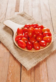 Tomato fresh in wooden bowl on wood table