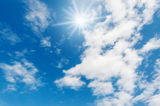 Blue sky with white cloud and sunray for design