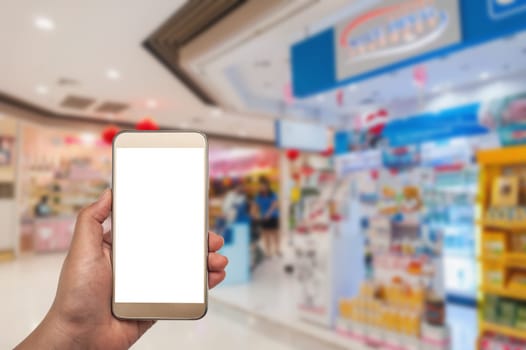 The women using smartphone in shopping mall on blurred background
