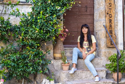 nice girl posing sitting in an ancient village called Calcata, Italy