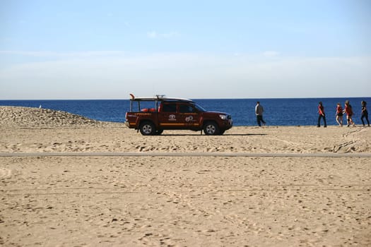 Long Beach,United States - December 26,2015: An ambulance with lifeguards patrols along the beach of Long Beach,where athletes train on December 26,2015 in Long Beach.