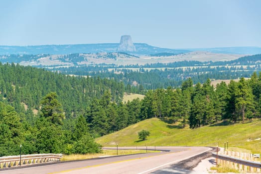 Highway in Wyoming with Devils Tower National Monument visible in the background