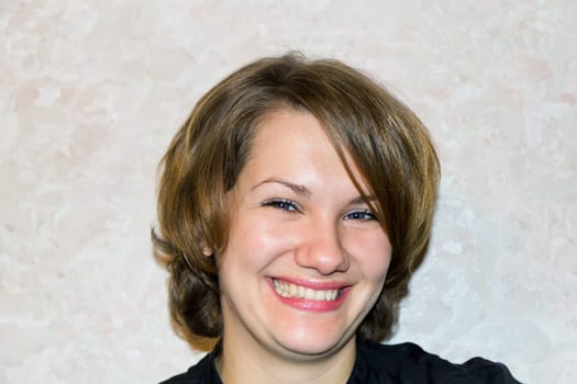 Photo of young smiling  woman with brown hair
