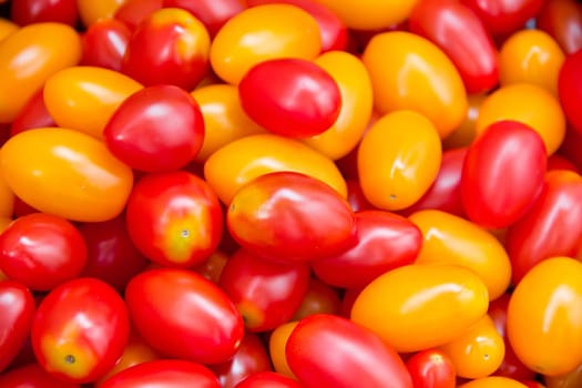 Photo of background with fresh red and yellow tomatos