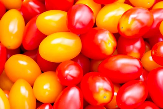 Photo of background with fresh red and yellow tomatos