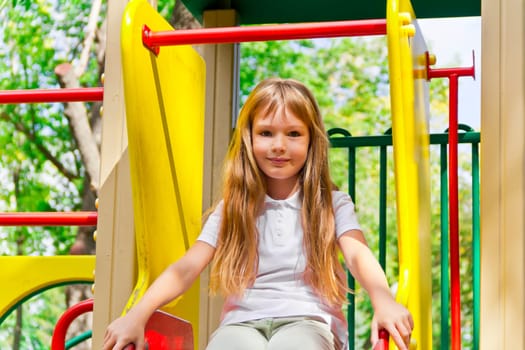 Photo of active girl on nursery platform in summer
