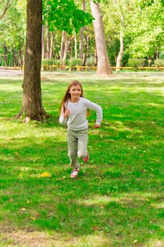 Photo of cute running girl in summer