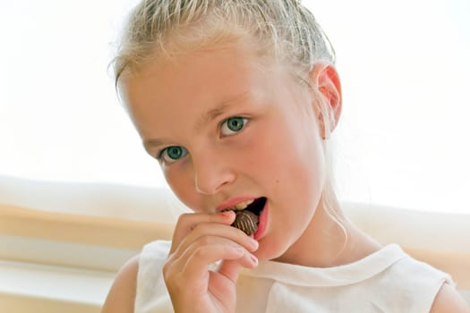 Photo of eating cute girl with blond hair