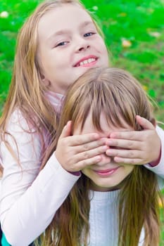 Photo of two playing girls in summer