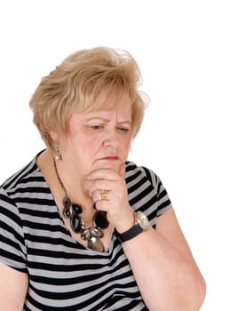 A seventy year old woman with one hand on her chin thinking hard about.her problems, isolated for white background..