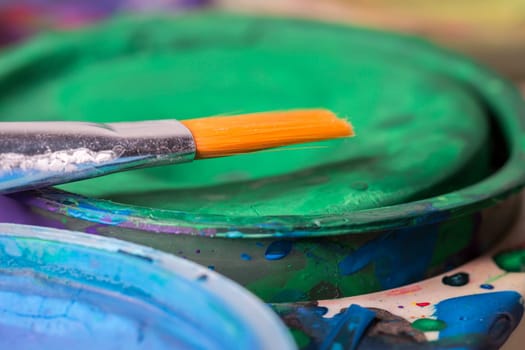 Paintbrush Close Up with water colour palette.