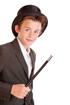 Cute young boy dressed as a magician in a top hat and jacket waving a wand in his hand, upper body isolated on white