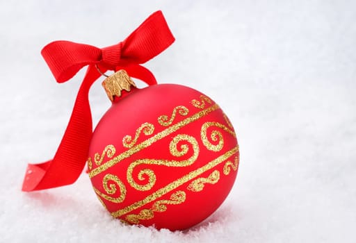Christmas decorations Red Christmas ball with ribon in the snow