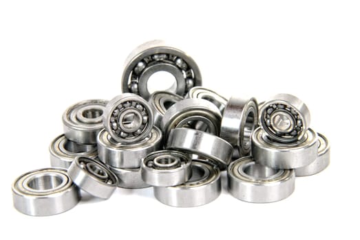 lot of small ball bearings on the white background