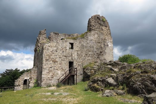 Primda castle - the one from the oldest stone castles in Czech republic..The first mention of Primda castle dates from the year 1121..The ruins of the castle Primda stands at the southern end of the rocky ridge above the Primda village on Tachov Region. Primda is considered to be the oldest surviving stone castle in Bohemia and is protected as a national monument. The castle has been preserved ruins of a massive rectangular Romanesque residential tower, which was built of quarried stone. Also there are remains of a cylindrical tower from the late 15th century..Primda, Czech republic.