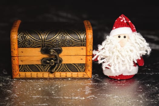Christmas Santa Claus or Father Frost and wooden chest on silver or metal grunge surface