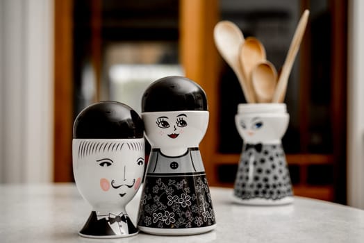 Three pods on the table, all three in theme of people, two females, one male. arranged in such a way as to represent infidelity.