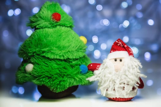 Santa Claus or Father Frost and fir tree on christmas lights background