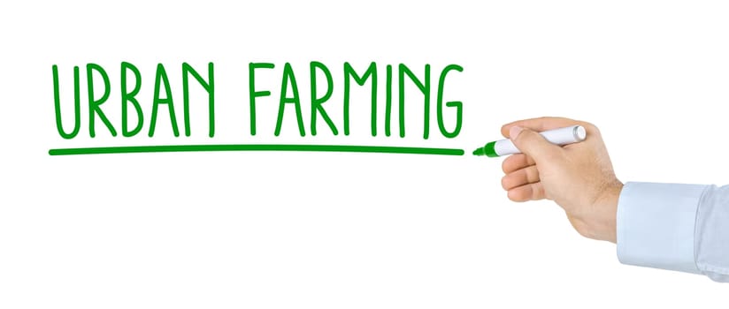 Hand with pen writes Urban Farming