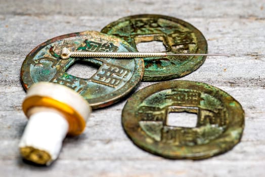 Acupuncture needle on ancient Chinese coin