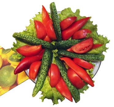 Sliced cucumbers and tomatoes on a plate on a white background