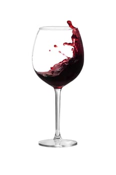 Red wine is splashing out of a wine glass
