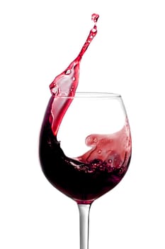 Red wine is splashing out of a wine glass