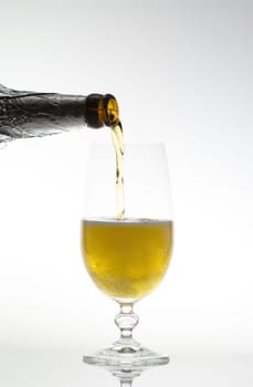Pouring beer into a glass with a bottle