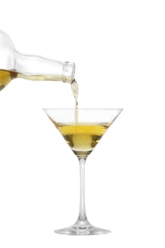 Pouring a liquid into a Martini glass isolated on white